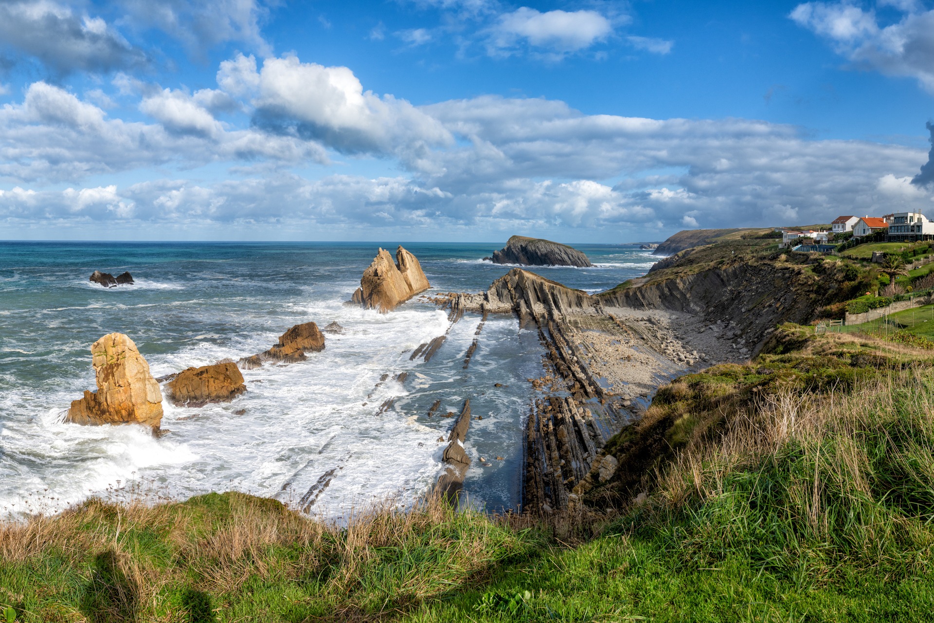 panorama of a rocky and wild coast with stormy waves hitting the Cantabrien