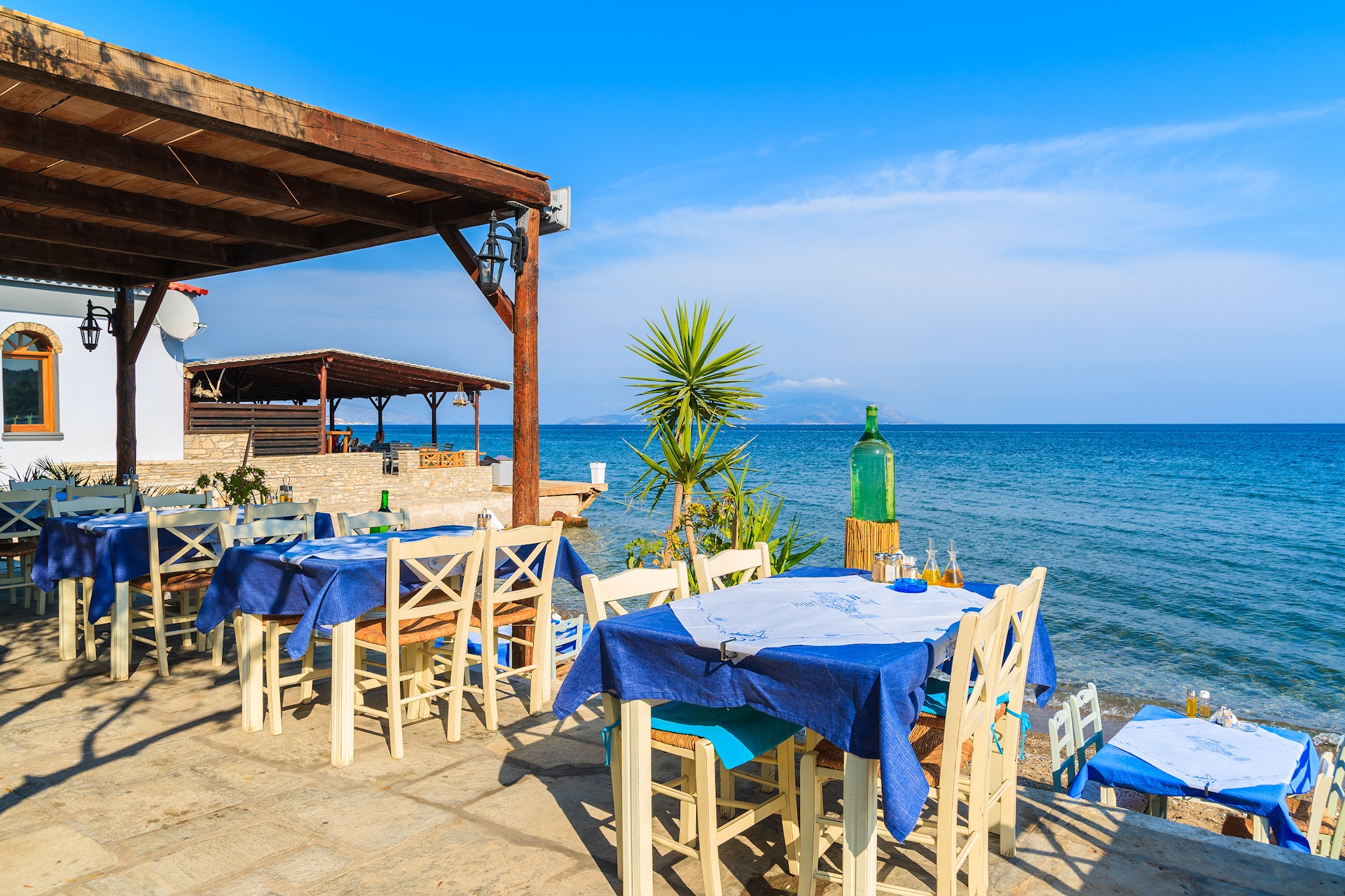 Typical Greek tavern in small fishing village on coast of Samos 1920x1280 sp Typical Greek tavern in small fishing village on coast of Samos