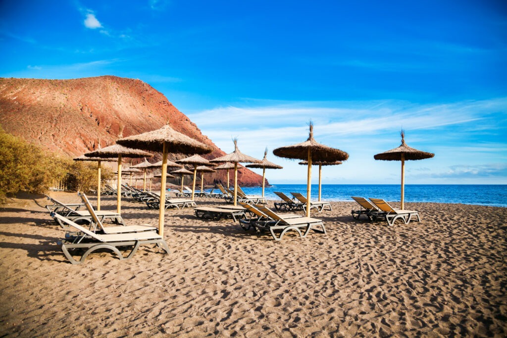 chaise-longues and sun umbrellas in Naturist Playa de la Tejita