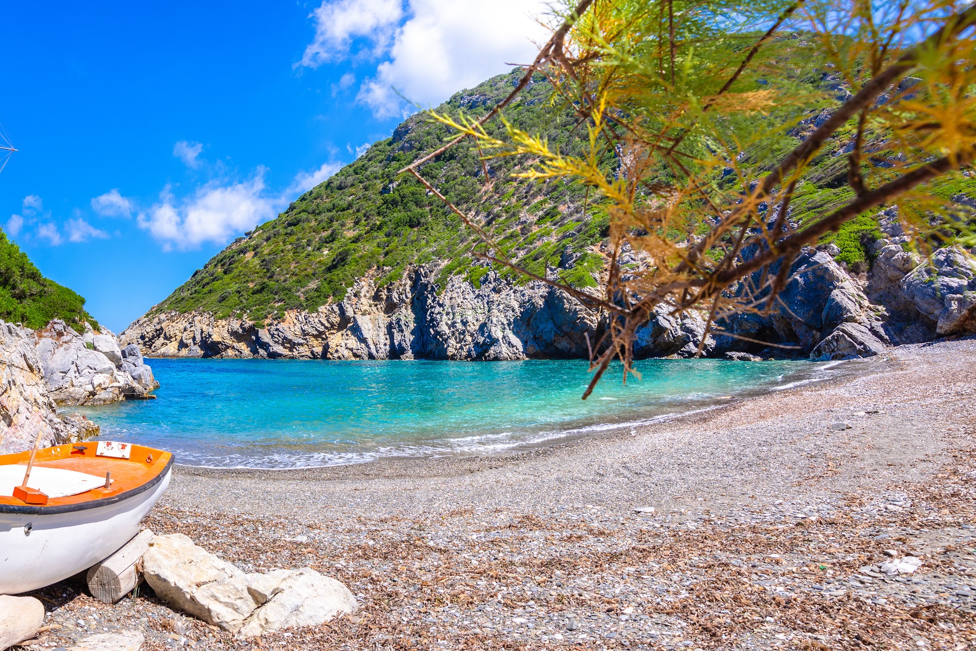 Gialia beach with old windmill in Alonnisos island, Greece
