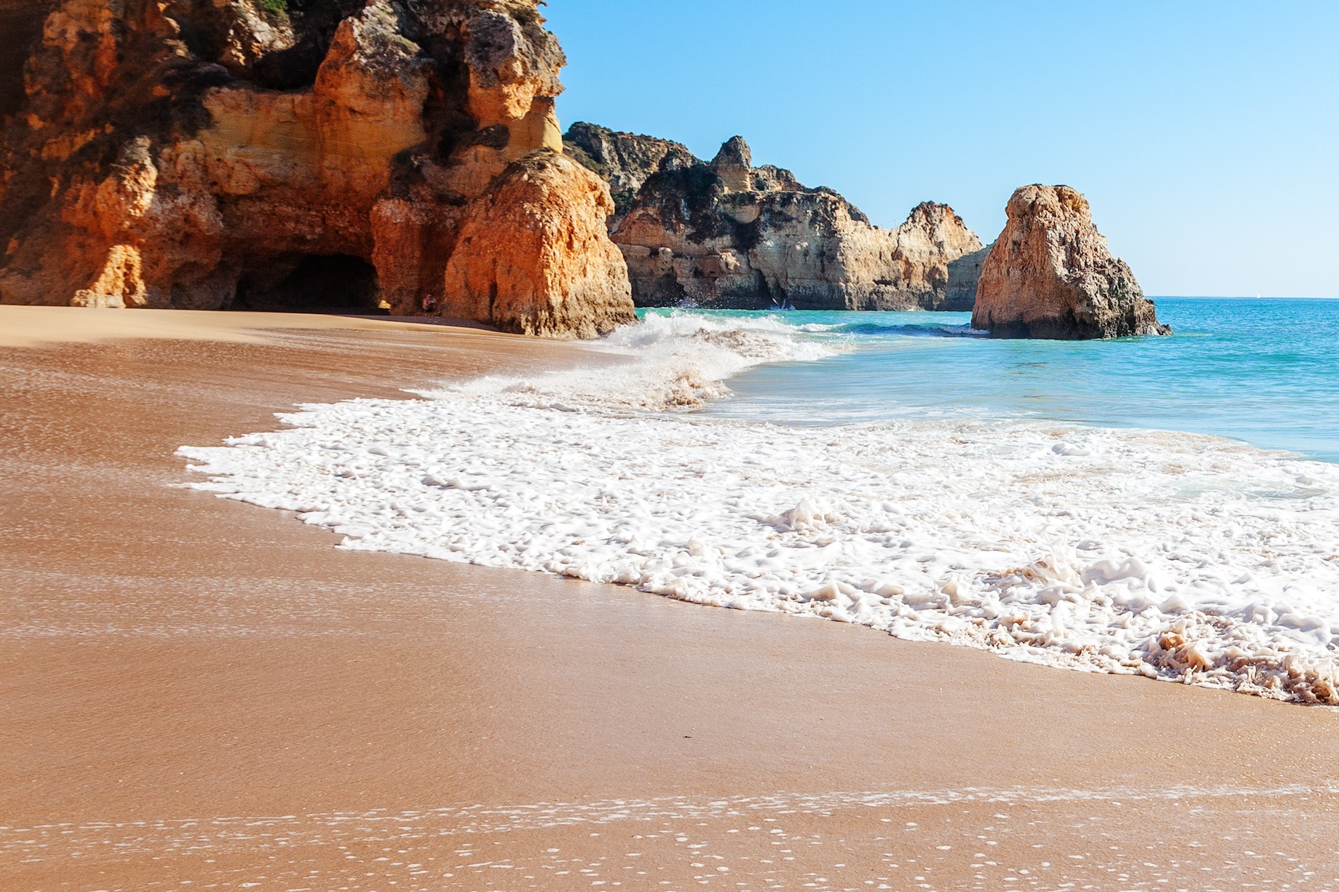 Summer sandy naturist beach (Algarve, Costa Vicentina, Portugal). 1920x1280 sp Topless young woman covering her breasts by hands