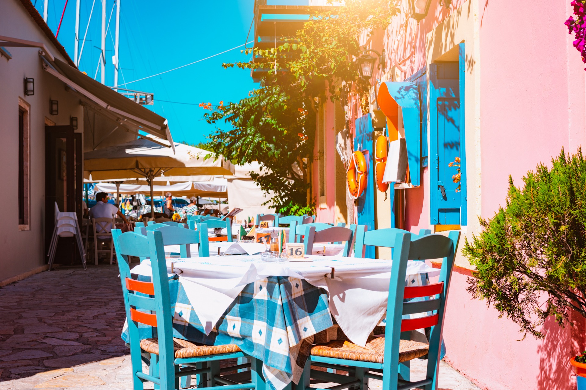 Traditional greek vivid colored tavern on the narrow Mediterrane FKK-Lifestyle