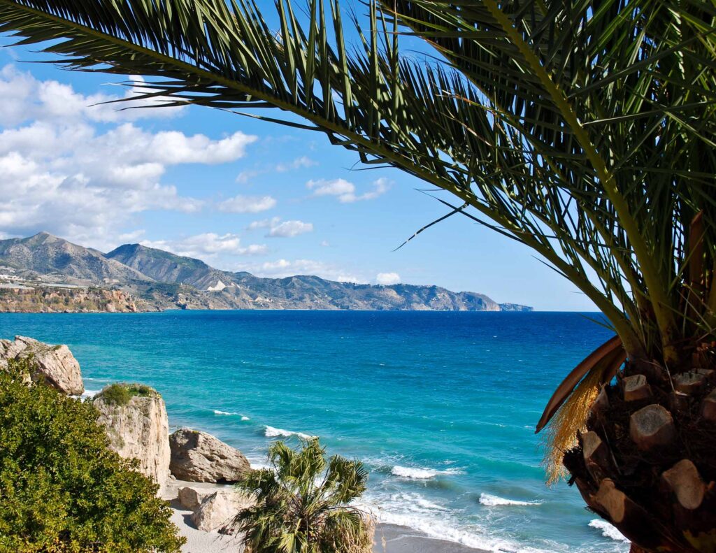 Nerja Beach and City - Spain FKK-Strand Sa Canova bei Son Serra de Marina auf Mallorca – naturbelassener, langer Sandstrand mit türkisblauem Meer und Blick auf das Tramuntana-Gebirge.